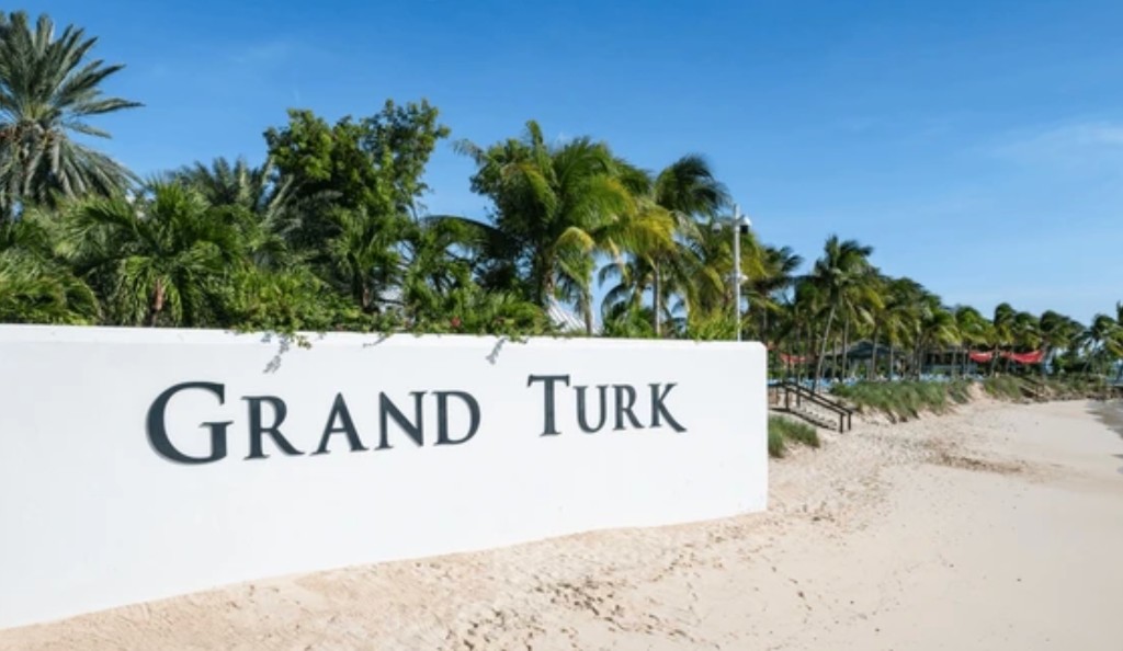 Grand Turk Cruise Center beach with GRAND TURK sign and palm trees